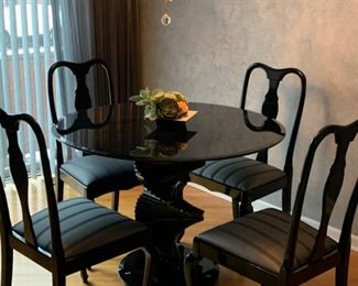 $775--black glass art table, round table, $375--4 black lacquer chairs