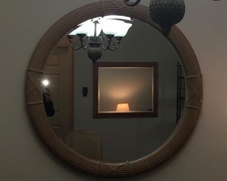 Round mirror with reflection of beveled wall mirror