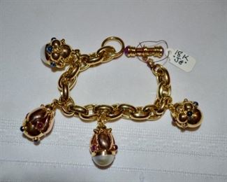 18k gold charm bracelet (60.6g) $3,200