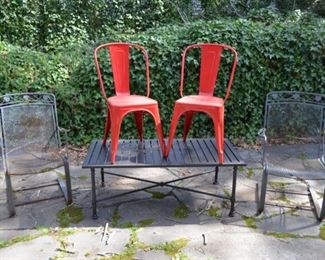 wrought iron chairs; metal table (glass top not shown), red metal chairs from France