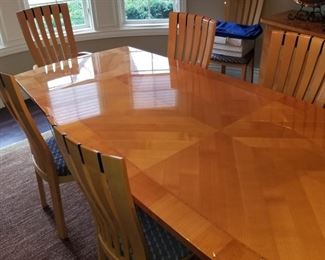 Stunning dining room table with 2 captain chairs and 8 side chairs.  Also includes buffet. Leaf extensions on each end hide away under table.  Set $2,300