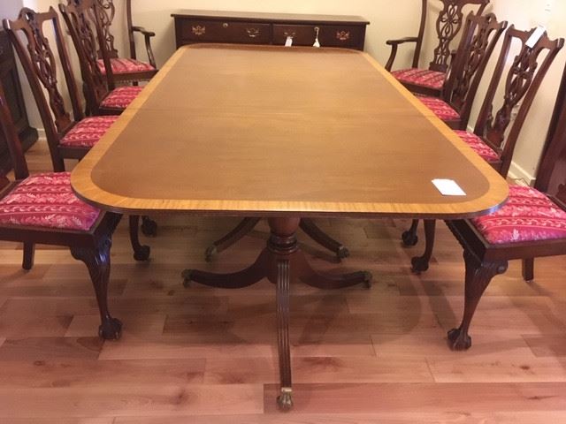 #003 Dining Table, satinwood edge, thin profile, on metal, claw foot casters with 2 additional leaf extensions; also shown #004, Set of 8 Chippendale-style chairs, priced separately.