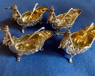 $1,050 for all.  Set of 4 Baroque Cherub and Shell Open Salt Cellars with Spoons; 3.25 in long x 1.5 in wide x 2.5 in tall.
