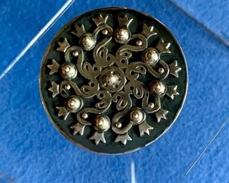 $140 Mid Century Modern round sterling pin.  Signed "Los Castillo".  2.25 in diameter, approx 33 g. 