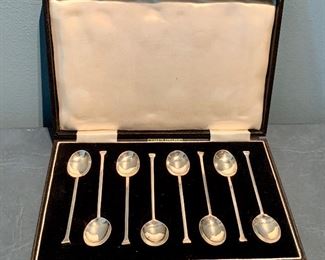 $195 Eight English made demitasse spoons in box.
