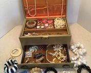 Vintage jewelry box with an assortment of costume jewelry. Includes a couple Sterling pieces