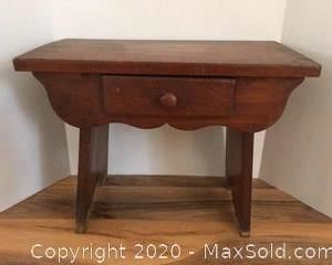 Small wooden antique table stool with drawer.