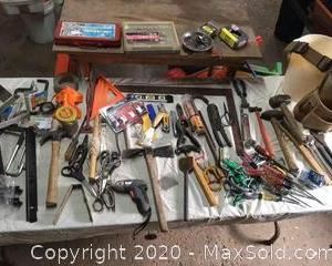 An assortment of tools with a wooden work bench 