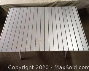 Collapsible aluminum table with carrying bag.