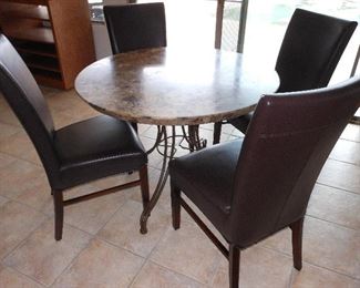 Table with four faux leather chairs. Excellent condition.  