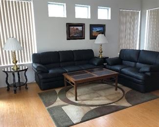 Black Sofa and Loveseat, Sofa Table, 2 Coffee Tables, End Tables, Area Rug x 2, Stiffel Lamps x 2, Art