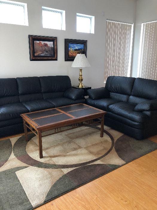Black Sofa and Loveseat, Sofa Table, 2 Coffee Tables, End Tables, Area Rug x 2, Stiffel Lamps x 2, Art