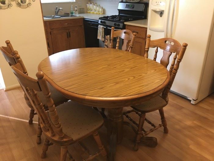 . . . a nice oak table and four chairs -- two leaves come with this fine set