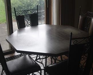 MCM  ~ OCTAGON 42 INCH CAST IRON TABLE  AND 4 CAST IRON CHAIRS  ~ VERY HEAVY SET. TOP HAS FADING AS SEEN ~ $95