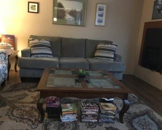 Ashley Grey Microfiber Sofa, Oak Coffee Table with leaded glass top, DVD's, Area Rug (size 89.5in x 63in).