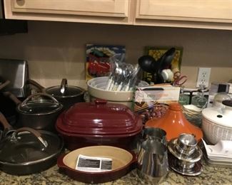 Ceramic Baking Dishes, Ceramic Nesting Bowls, Flatware, Pots and Pans, Stainless Steel Espresso Cups and Pitcher.