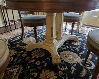 BASE OF DINING TABLE ....LARGE BLACK & GOLD RUG