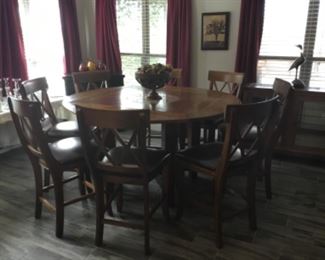 Breakfast table that turned into three different shapes. This is a round table with 8 barstools.
( table & barstools will not go half price)