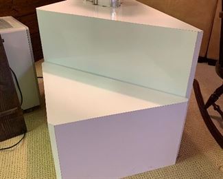 White triangular side table with smaller matching side table - both in great condition.  Dimensions of larger 44"l x 25"h x 22"d. Small 30.5"x 14"h x 15.5"d.  Price for set $150