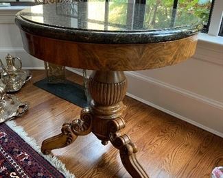 Marble top on a burled walnut frieze with molded edge resting on a bulbous shaped center column raised on three carved scroll legs.  Excellent condition.  Dimensions 31"did x 32"h  Price $2400