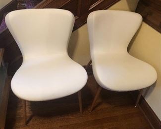 Set of 4 identical mod white upholstered chairs with leather-feel vinyl on seats. (Only 2 shown) Very comfortable!