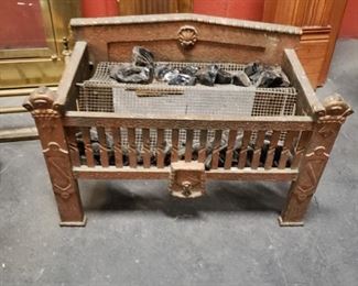 Antique copper painted metal fire place grate with amber coals 