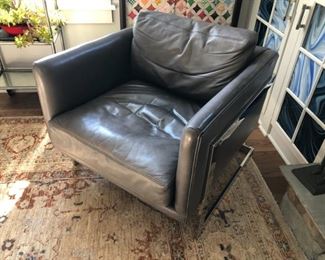 This grey leather chair with chrome legs was made by Milo Buaghman for Thayer Coggin Inc. Measures 31"l x 29"w x 24.5"h.  