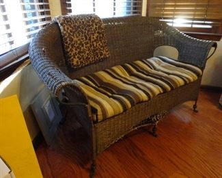 Rattan Love seat with very heavy metal body (note in front the lovely touch the visiting dog left)