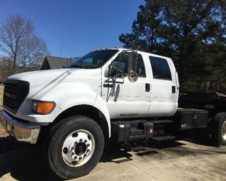 2000 Ford F750 65328 with a 36x8 drop deck trailer.