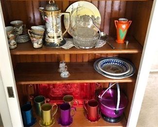 Colored cups and ice bucked on bottom shelf has sold