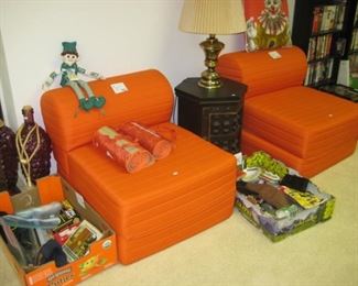Orange chairs convert to child's bed