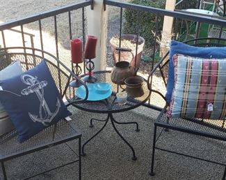Wrought iron chairs, side table, pillows