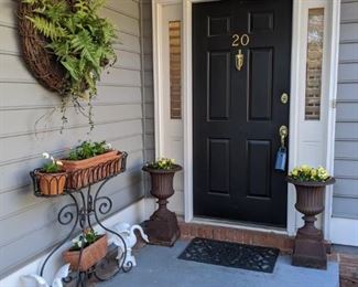 Front entrance with pair of vintage cast iron planters on stands, cast iron planter with extra-butch pansies and violas, cast iron geese with mad cow disease and hand crafted grape/kudzu vine wreath, with all kinds of spring-y details: mushrooms, bird nest, doo dads.