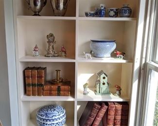 Shelf full of travel booty - some very nice leather-bound antique books, more blue/white porcelains.