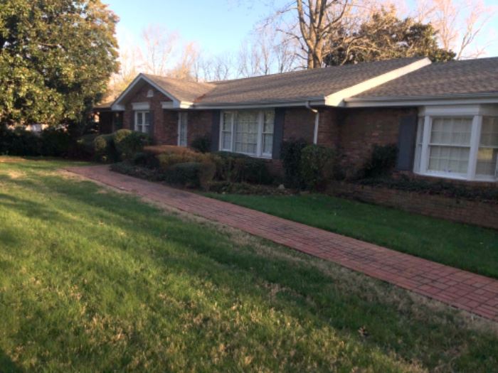 Long ranch resting on a beautiful lot, a fabulous brick patio area with detached two car garage. 