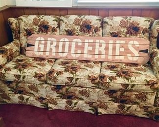 Vintage sofa & modern groceries sign