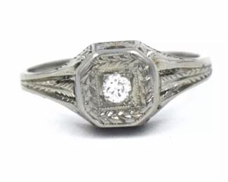 PLL #733 Antique Art Deco diamond ring featuring an ~.07 carat Old European cut diamond in an Art Deco millwork and filigree mounting crafted of 18k white gold. The size 5.25 ring is marked "18K" inside the shank.
Metal: 18k white goldWeight: 3.4 grams
Diamond: Cut: Old European
Carat: ~.07ct Size: 5.25 Condition: Metal has light scratches and scuffs. Diamond is well set and free from chips with no visible abrasions. $120
