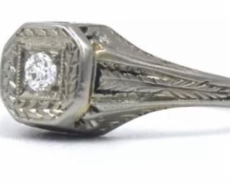PLL #733 Antique Art Deco diamond ring featuring an ~.07 carat Old European cut diamond in an Art Deco millwork and filigree mounting crafted of 18k white gold. The size 5.25 ring is marked "18K" inside the shank.
Metal: 18k white goldWeight: 3.4 grams
Diamond: Cut: Old European
Carat: ~.07ct Size: 5.25 Condition: Metal has light scratches and scuffs. Diamond is well set and free from chips with no visible abrasions. $120