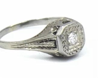 PLL #733 Antique Art Deco diamond ring featuring an ~.07 carat Old European cut diamond in an Art Deco millwork and filigree mounting crafted of 18k white gold. The size 5.25 ring is marked "18K" inside the shank.
Metal: 18k white goldWeight: 3.4 grams
Diamond: Cut: Old European
Carat: ~.07ct Size: 5.25 Condition: Metal has light scratches and scuffs. Diamond is well set and free from chips with no visible abrasions. $120