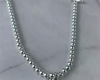 $75 Tiffany & Co. Return to Tiffany Heart Bead Bracelet is in excellent condition. Bracelet measures 7 inches in length. Features a sterling silver tag with Tiffany Pink enamal finish on a bead bracelet. Clasp is stamped 925 and back of heart charm is stamped ¡°Tiffany & Co. 925¡