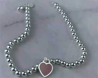 $75 Tiffany & Co. Return to Tiffany Heart Bead Bracelet is in excellent condition. Bracelet measures 7 inches in length. Features a sterling silver tag with Tiffany Pink enamal finish on a bead bracelet. Clasp is stamped 925 and back of heart charm is stamped ¡°Tiffany & Co. 925¡