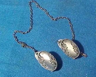 vintage sterling silver baby bib clips from the early 20thc..features ornate designs and is all in very good condition with no damages or excessive wear-its complete with chain and is signed sterling..