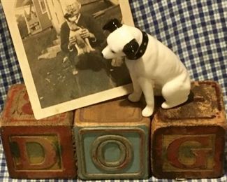 Original set of old wooden Troy ABC blocks that spell out DOG and has illustrations of animals. Also included is an antique RCA Nipper dog figurine and early 1900s photo real snapshot of a man and his dog.