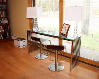 Modern chrome & glass console
Pair Adjustable modern wood & chrome stools 
Pair glass table lamps – 1 small chip, shades some creasing
