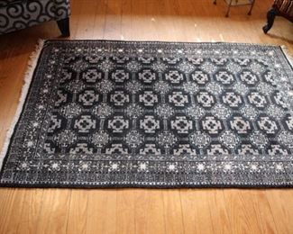 Oriental black ground small rug