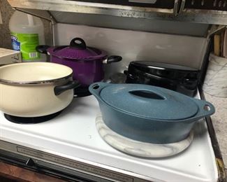 Packed kitchen with pots, pans, essentials 