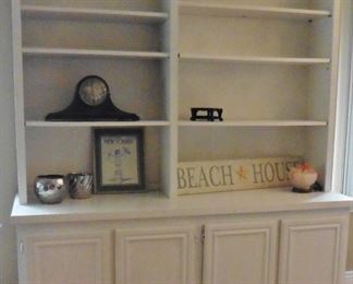 Painted white bookcase over storage cabinet