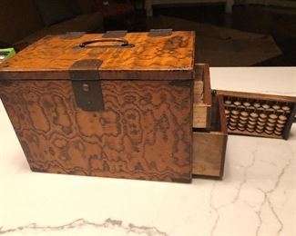 Side view of antique chinese accountant box with drawers and abacus   