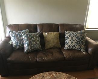 This is a well-cared-for brown leather couch -- pillows not included.