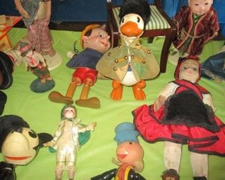 The doll collection includes some antique  Disney dolls: note the Pinochio, Donald Duck, Mickey Mouse, and Jiminy Cricket